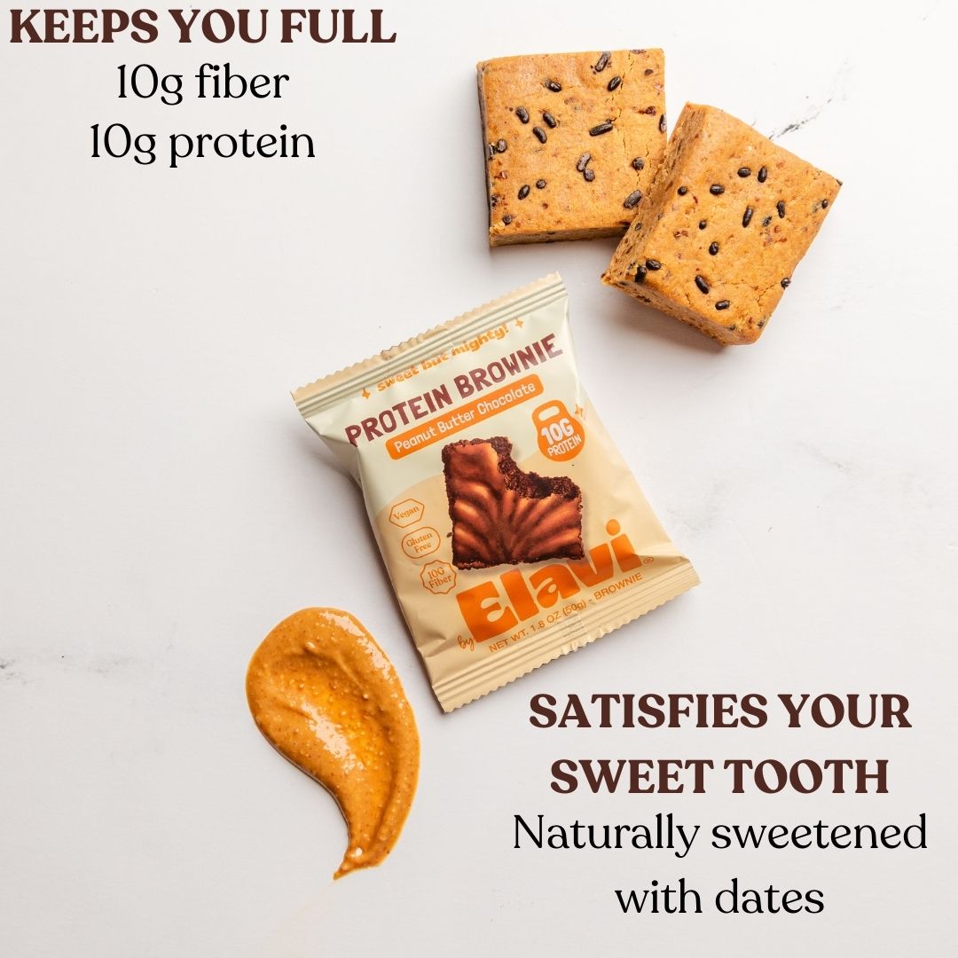 Top-down view of Protein Brownie peanut butter chocolate package and two brownie squares showcasing 10g fiber 10g protein overlay text on white marble background