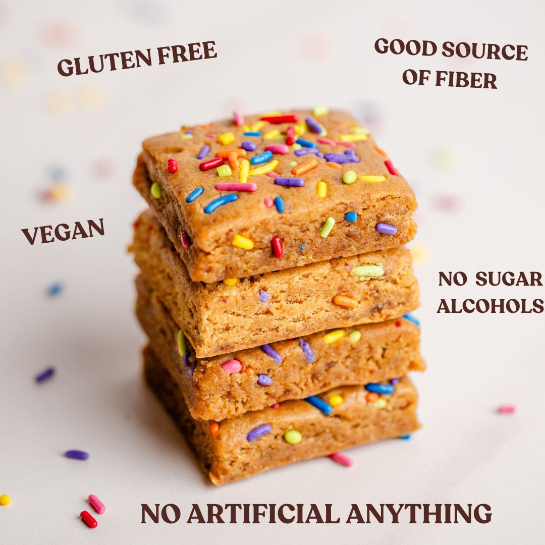 Close-up of Protein Brownie 3 Flavor Bundle stacked brownies with sprinkles and NO ARTIFICIAL ANYTHING overlay