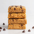 A stack of Elavi Chocolate Chip Cookie Dough flavored protein brownies.